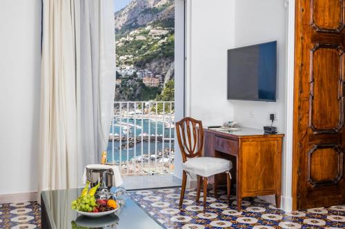 a room with a desk and a window with a view at Hotel Marina Riviera in Amalfi