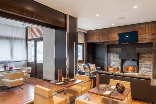 a living room with a couch and a fireplace at Eurostars Royal Tanau in Baqueira-Beret