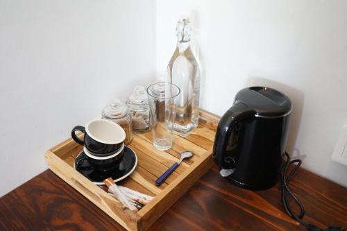 a wooden tray with a coffee maker and a coffee pot at Sukacita Hill in Uluwatu