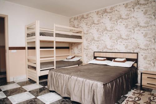 a bedroom with two bunk beds in a room at Hotel VIZA in Solotvyno