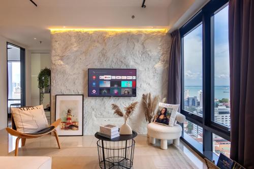 a living room with a large stone wall at Tropicana 218 Macalister Penang in George Town