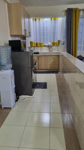 a kitchen with a counter and a refrigerator and a counter at Elegant One Bedroom Garden Estate in Nairobi