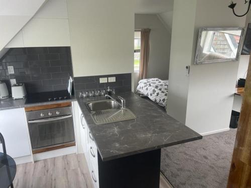 a kitchen with a sink and a counter top at Ohope Dreamer 2 in Ohope Beach