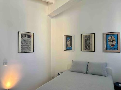 una camera con un letto con quattro quadri sul muro di Loft industriel en duplex - The Urban Garage a Losanna