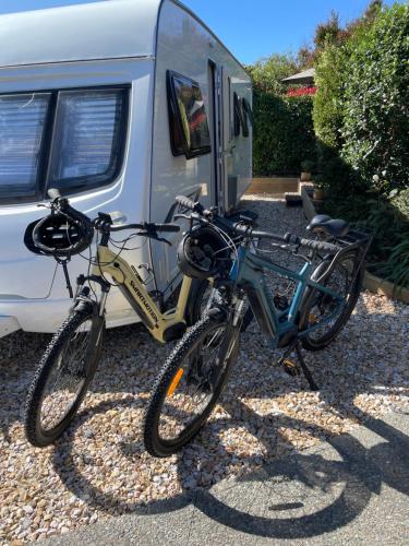 two bikes are parked in front of a trailer at Cosy caravan fun in sunny Nelson with wifi! in Nelson