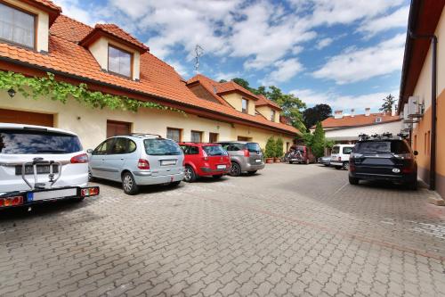 a group of cars parked in a parking lot at Penzion U Zamku in Lednice
