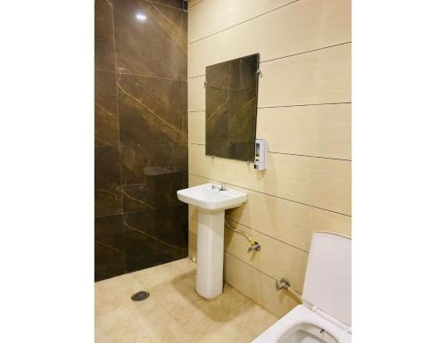 a bathroom with a sink and a toilet at Hotel Sita Niwas Since 1965, Amritsar in Amritsar
