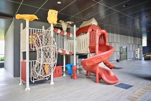 a childrens play area with a slide and a playground at BRAND NEW 2BR Apt Menara Jakarta, Jkt Inter Expo in Jakarta