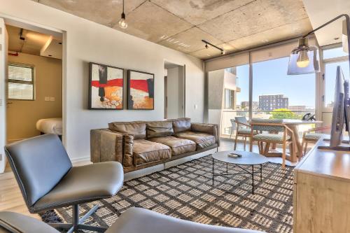 a living room with a couch and a table at The Quarter Apartments in Cape Town