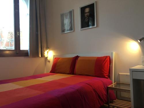 a bedroom with a bed with a colorful blanket at Residence Villa Rendina in Mestre