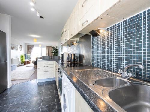 a kitchen with two sinks and a counter top at Pass the Keys Free Parking and Walking Distance Etihad Coop Arena in Manchester