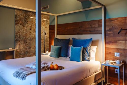 a bedroom with a large bed with blue pillows at Albergo La Pace in Segni