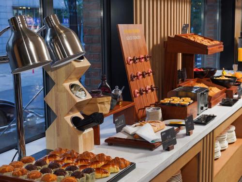 a bakery counter with pastries and other food items at Park Inn by Radisson Tianjin Five Old Street Nanjing Road in Tianjin