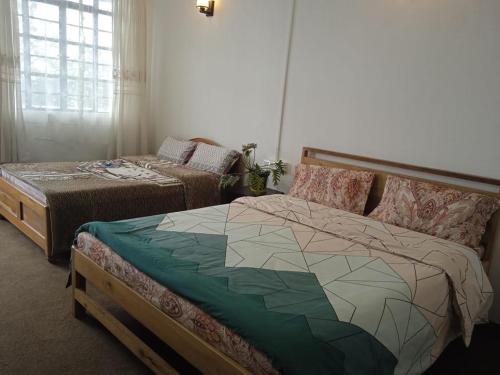 A bed or beds in a room at Vilasa Homestay