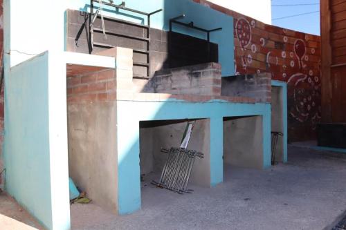 a building with a blue table and stairs on it at Cabañas Caudiel in Caudiel
