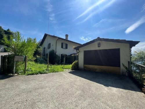 a garage in front of a white house at Charming house with a lake view in Luzern