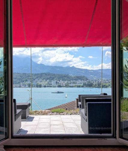 a window with a view of a body of water at Charming house with a lake view in Luzern