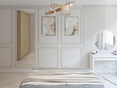 een witte slaapkamer met een bed en een spiegel bij Apartamenty Noworudzki Raj „Słupiec” in Nowa Ruda