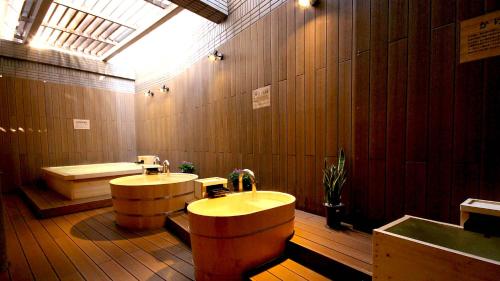 a large bathroom with two sinks and a bath tub at Hotel Cypress Karuizawa in Karuizawa