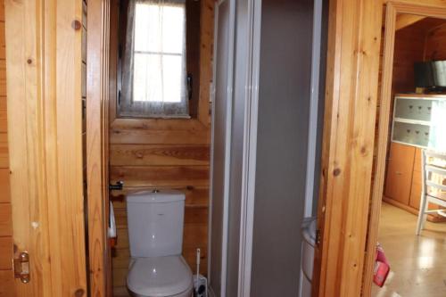 a bathroom with a toilet in a wooden house at Cabañas Caudiel in Caudiel