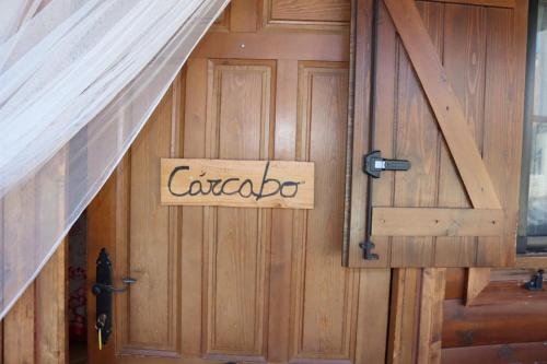 a wooden door with a sign that reads car garage at Cabañas Caudiel in Caudiel