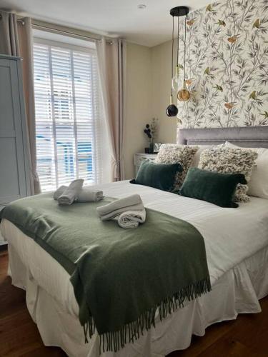a bedroom with a large bed with towels on it at Isfryn, holiday home in Aberdyfi in Aberdyfi