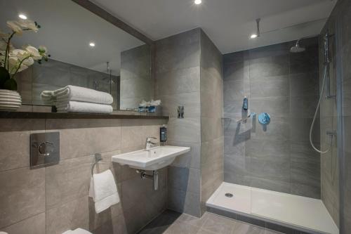 bagno con lavandino e doccia di Maldron Hotel Sandy Road Galway a Galway