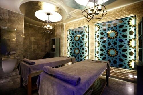 a treatment room with two beds and a sink at Sunprime C-Lounge - Adult Only in Alanya