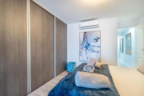 a bedroom with a bed with a blue blanket at Beachhouse GALORE in Estepona