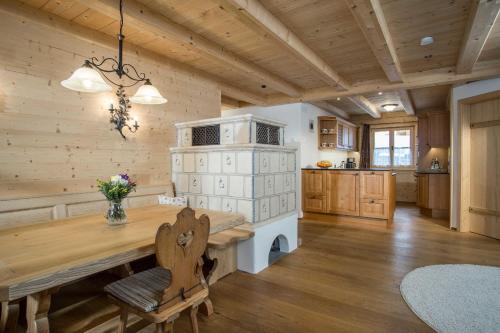 a kitchen with a wooden floor and a wooden table at Ferienwohnung Tegernsee,Fam Schneider, Kreuth-Grüneck in Kreuth