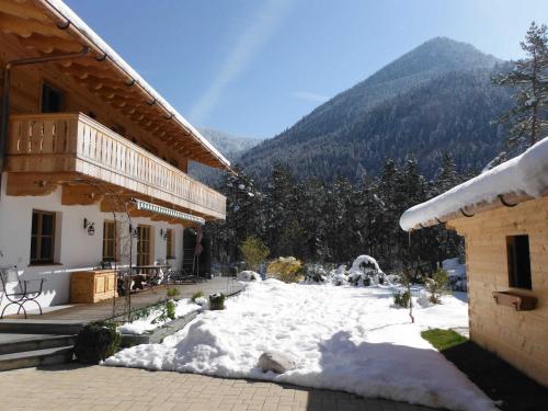 a snow covered yard in front of a building at Ferienwohnung Tegernsee,Fam Schneider, Kreuth-Grüneck in Kreuth
