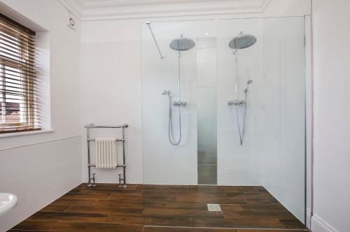 a white bathroom with a shower and a sink at Prospect House in York