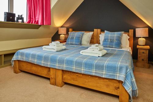 a bedroom with a bed with towels on it at Balnakeil Cattleman's Bothy in Durness