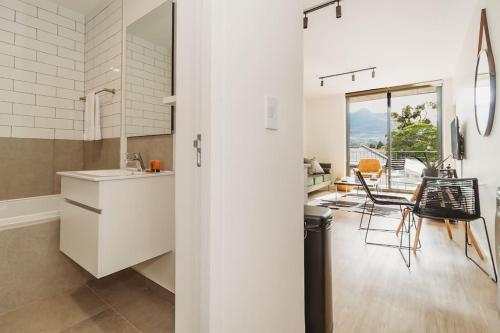 a kitchen with white cabinets and a dining room at 207 Le Jardin in George