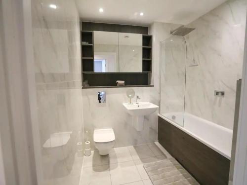 a bathroom with a toilet and a sink and a shower at Pass the Keys Central 3x King Bed Suite 5 Min Deansgate Station in Manchester