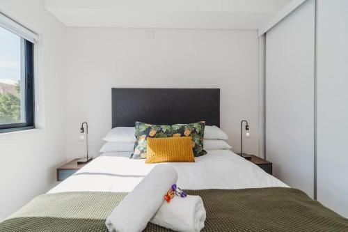 a bedroom with a large white bed with yellow pillows at 207 Le Jardin in George