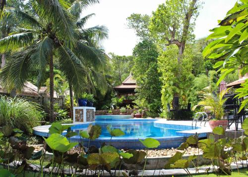 a swimming pool in the middle of a garden at Sabbay Kep in Kep