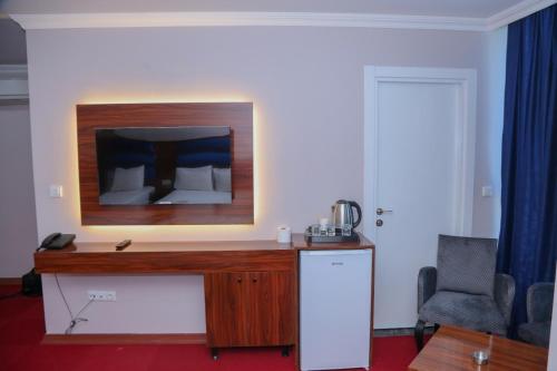 a desk in a room with a bed at Lion King Hotel in Esenyurt