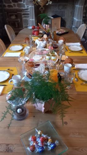 a wooden table with a christmas centerpiece on it at LA LANDE in Pleyber-Christ