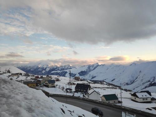 a view of a town with snow covered mountains at Mountain Dream House in Gudauri