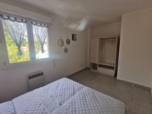 une chambre blanche avec un lit et une fenêtre dans l'établissement Villa Melody Santa Maria Poggio, à Santa-Maria-Poggio