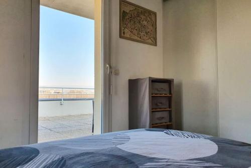 a bedroom with a bed and a large window at Le Castel d'Orne - Piscine et Terrasse in Caen