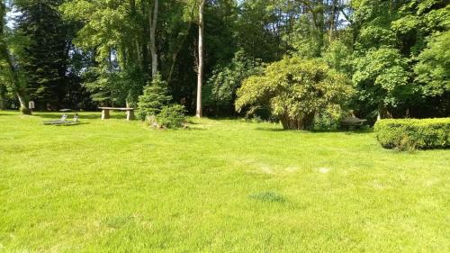 a park with a picnic table in the grass at LA LANDE in Pleyber-Christ