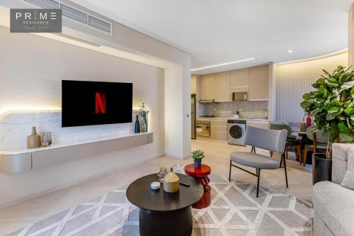 a living room with a tv on a wall at Prime Residence Sheikh Zayed in Sheikh Zayed