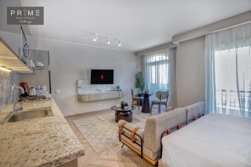 a kitchen and living room with a couch and a table at Prime Residence Kattameya in Cairo
