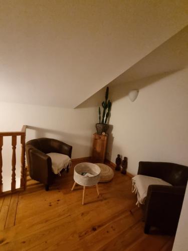 a living room with two couches and a table at ENTRE VENTOUX ET LUBERON Chambre d'hôte in Sault-de-Vaucluse