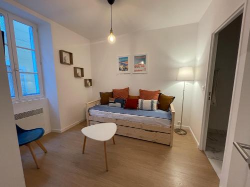 a small bedroom with a bed and a table at Nice and modern flat at the heart of Panier in Marseille - Welkeys in Marseille