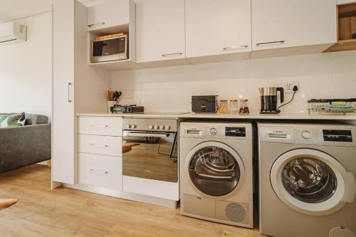 a kitchen with a washer and dryer in it at 304 Le Jardin in George