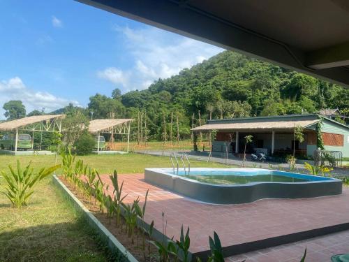 a house with a swimming pool in a yard at Kep Orchid Boutique Resort in Kep