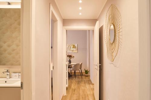 a hallway with a table and a mirror on the wall at Milan Retreats Porta Venezia in Milan